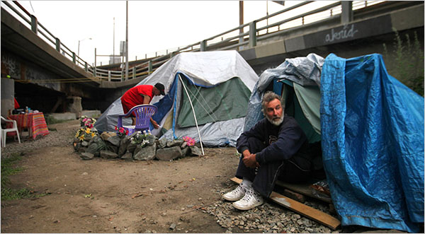 (Nicole Bengiveno/The New York Times -- Timothy Webb, 49, left, and Bruce, 59, live in a tent city, dubbed Camp Runamuck, in Providence, R.I., under an overpass stretch of Route 195 that is scheduled for demolition.)